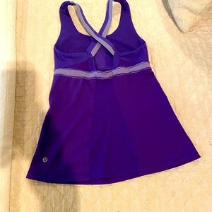 Lululemon purple tank with purple and white stripe detail.  Stash pocket front.